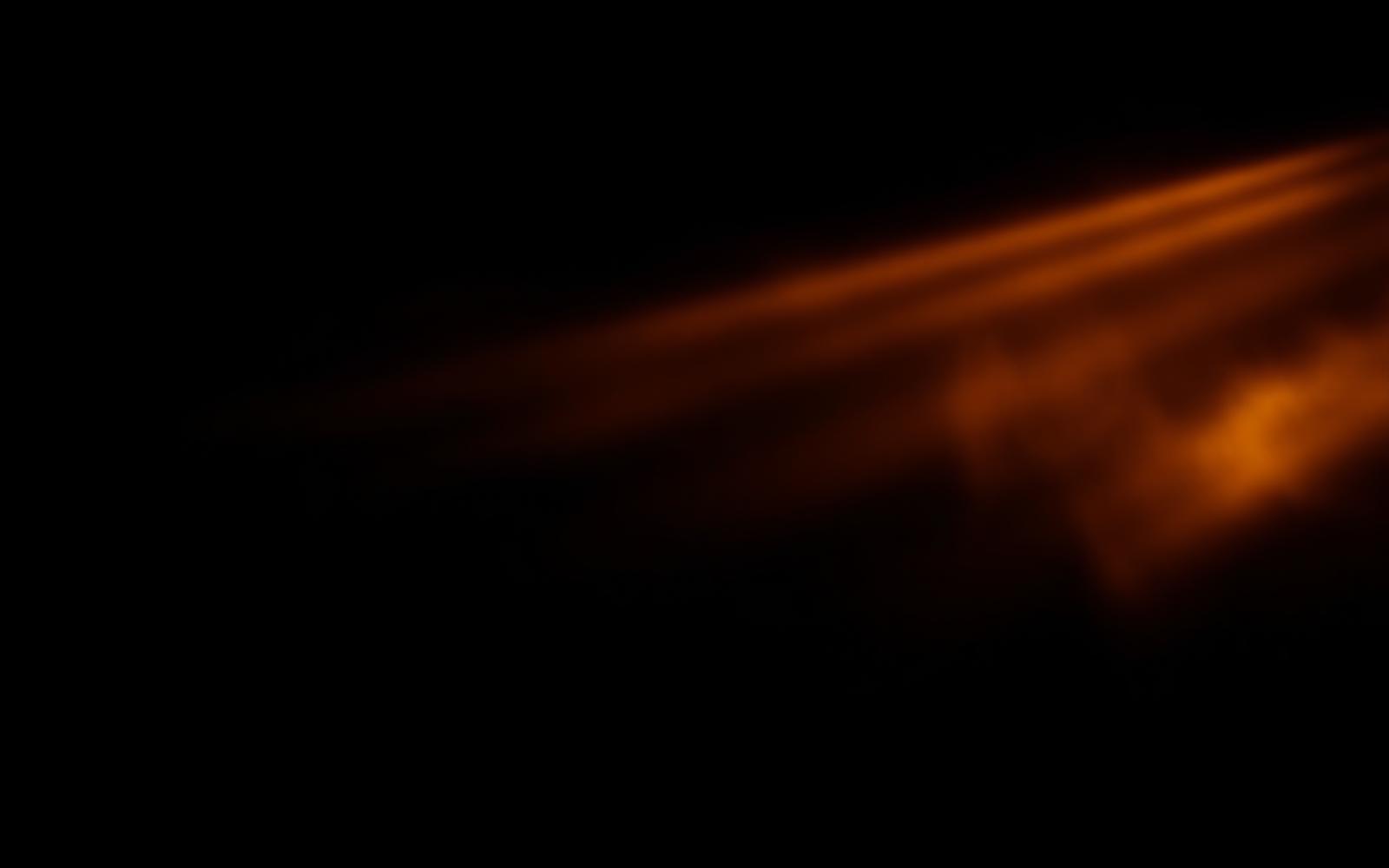Warm amber light cutting across a dark field